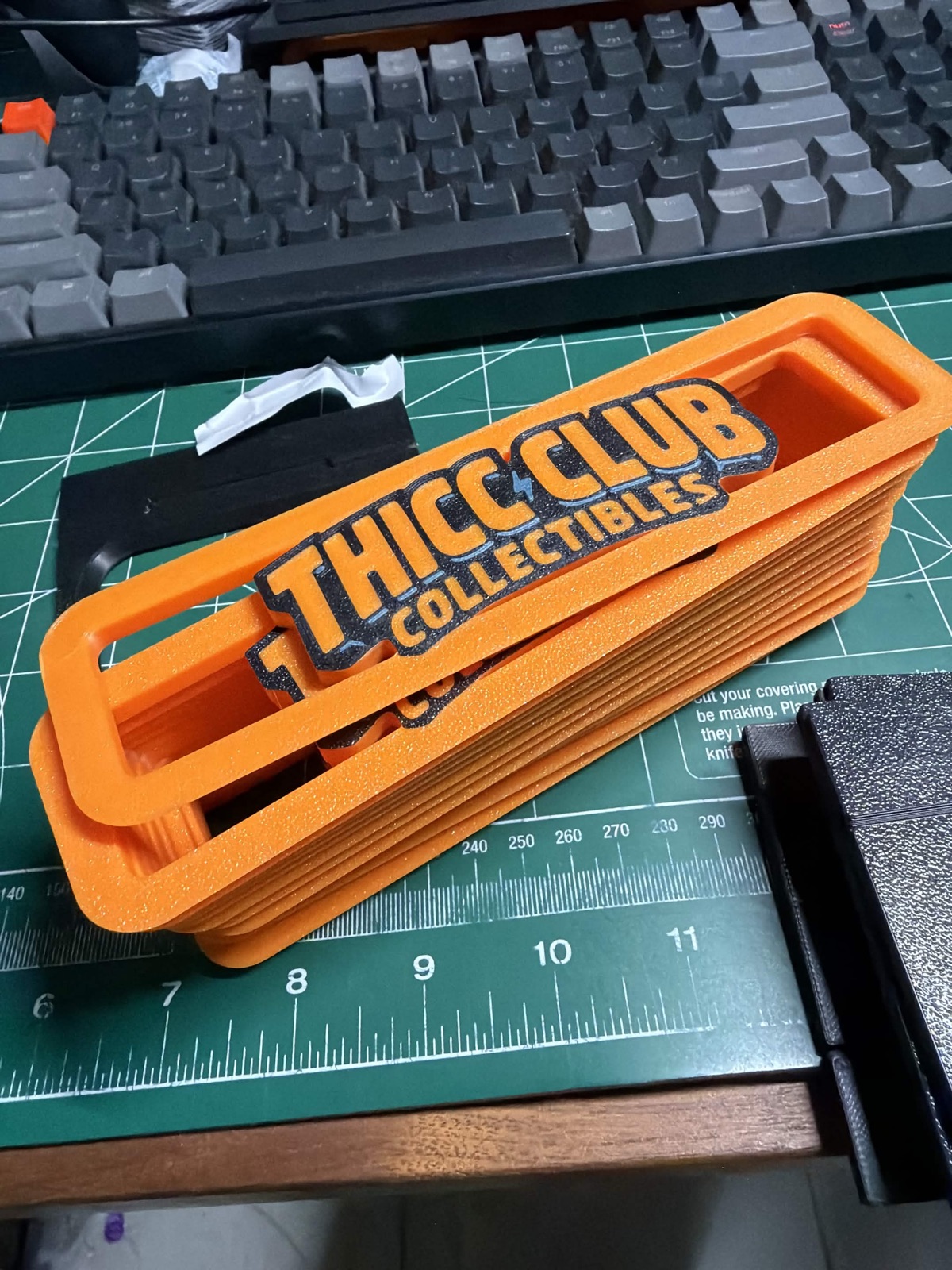 Close up stack of orange Thicc Club Prints risers